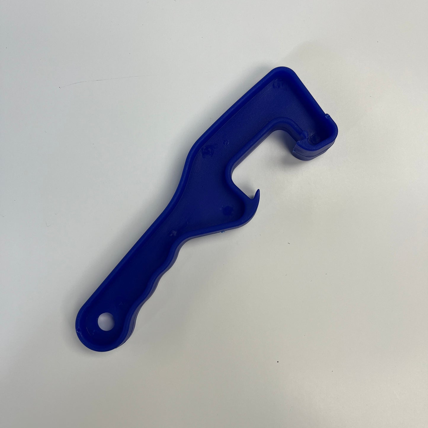 Blue plastic bucket lid opener on a white background