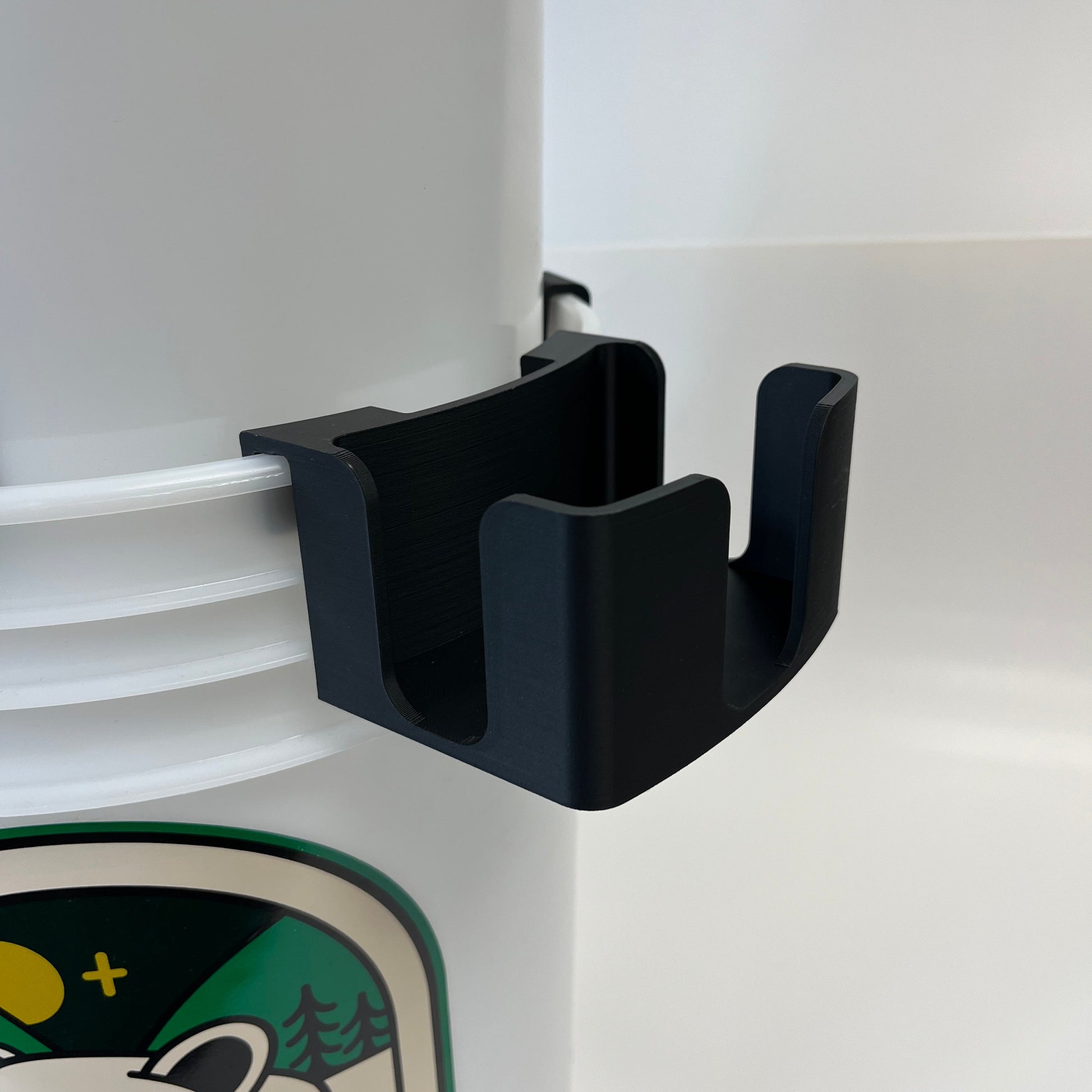 Black soap holder attached to a bucket