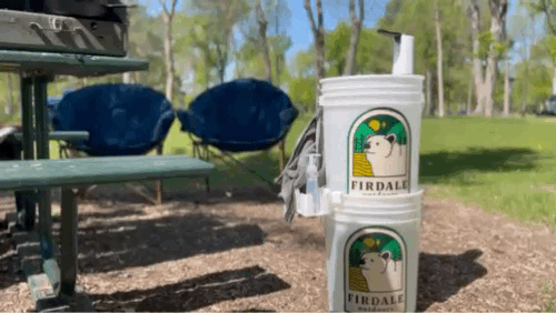 Video of person washing hands at a campsite